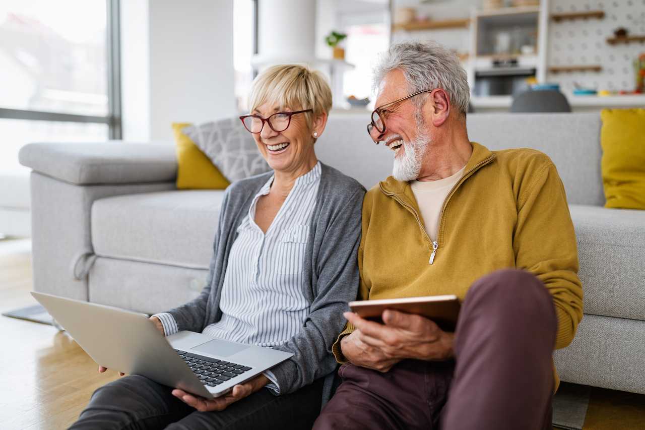 An older couple laughing and talking